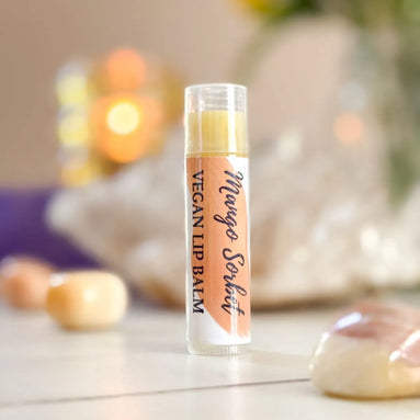 Organic vegan lip balm labeled Juicy Mango Sorbet with tropical mango flavor.