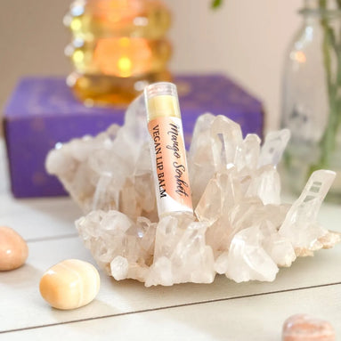 Mango-flavored vegan lip balm with citrus notes and creamy moisturizing texture.