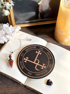 Wooden pendulum board engraved with Lilith sigil for divination and empowerment rituals.