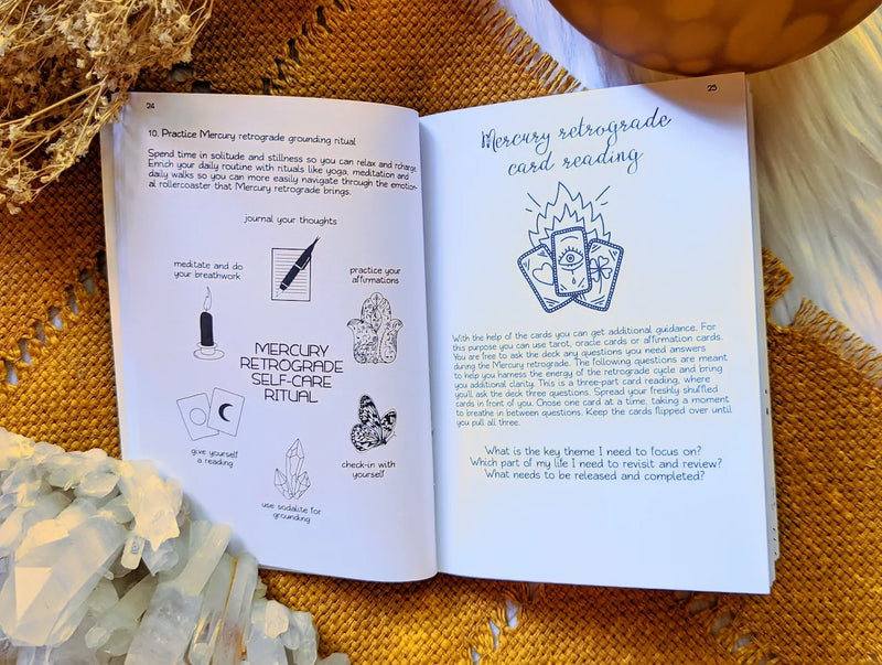 Open Mercury Retrograde journal displayed with crystals, candles, and astrology-inspired decor.