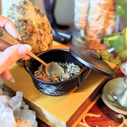 Money Magic Black Cauldron candle and crystals lifestyle photo