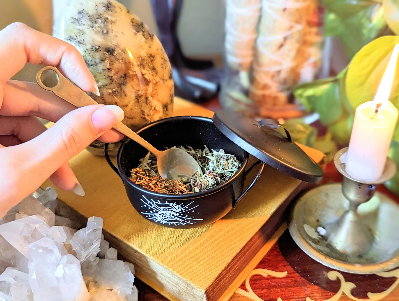 Money Magic Black Cauldron candle and crystals lifestyle photo