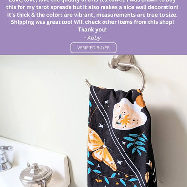 Positive review highlighting the quality, versatility, and celestial aesthetic of the tea towel.