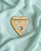 Heart-shaped planchette that doubles as an oracle card holder and crystal sphere stand.