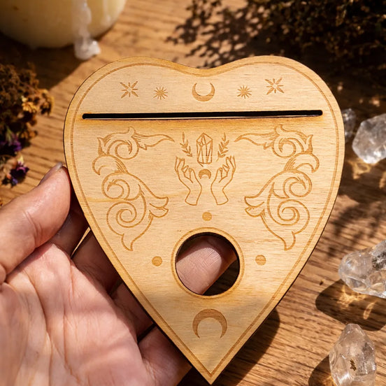 heart shaped planchette stand for holding oracle cards and crystal spheres in ritual space