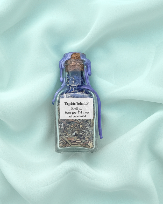 Small spell jar filled with herbs and symbolic ingredients for enhancing psychic intuition.
