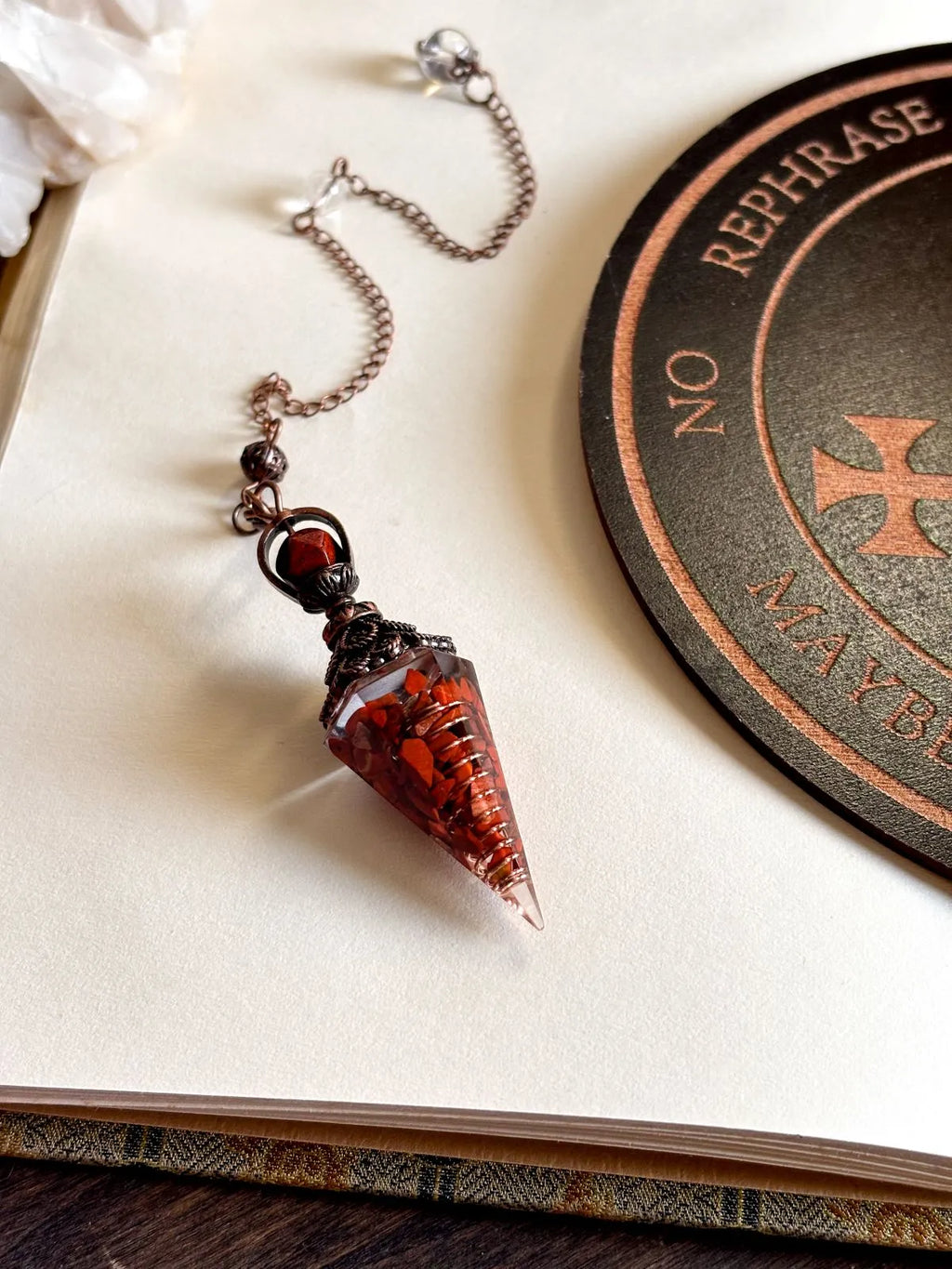 Handcrafted red jasper and copper pendulum for grounding and spiritual work.