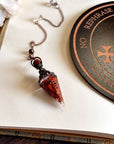 Handcrafted red jasper and copper pendulum for grounding and spiritual work.