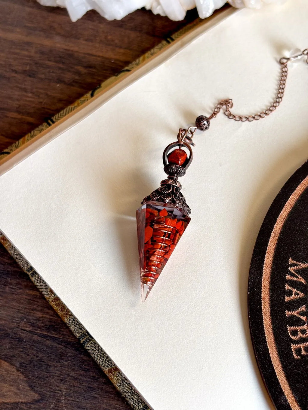 Handcrafted red jasper and copper pendulum for grounding and spiritual work.