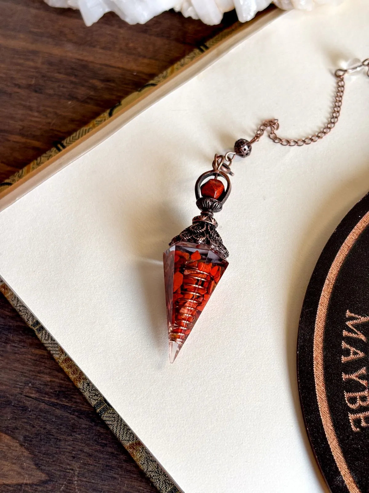Handcrafted red jasper and copper pendulum for grounding and spiritual work.