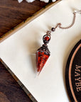 Handcrafted red jasper and copper pendulum for grounding and spiritual work.