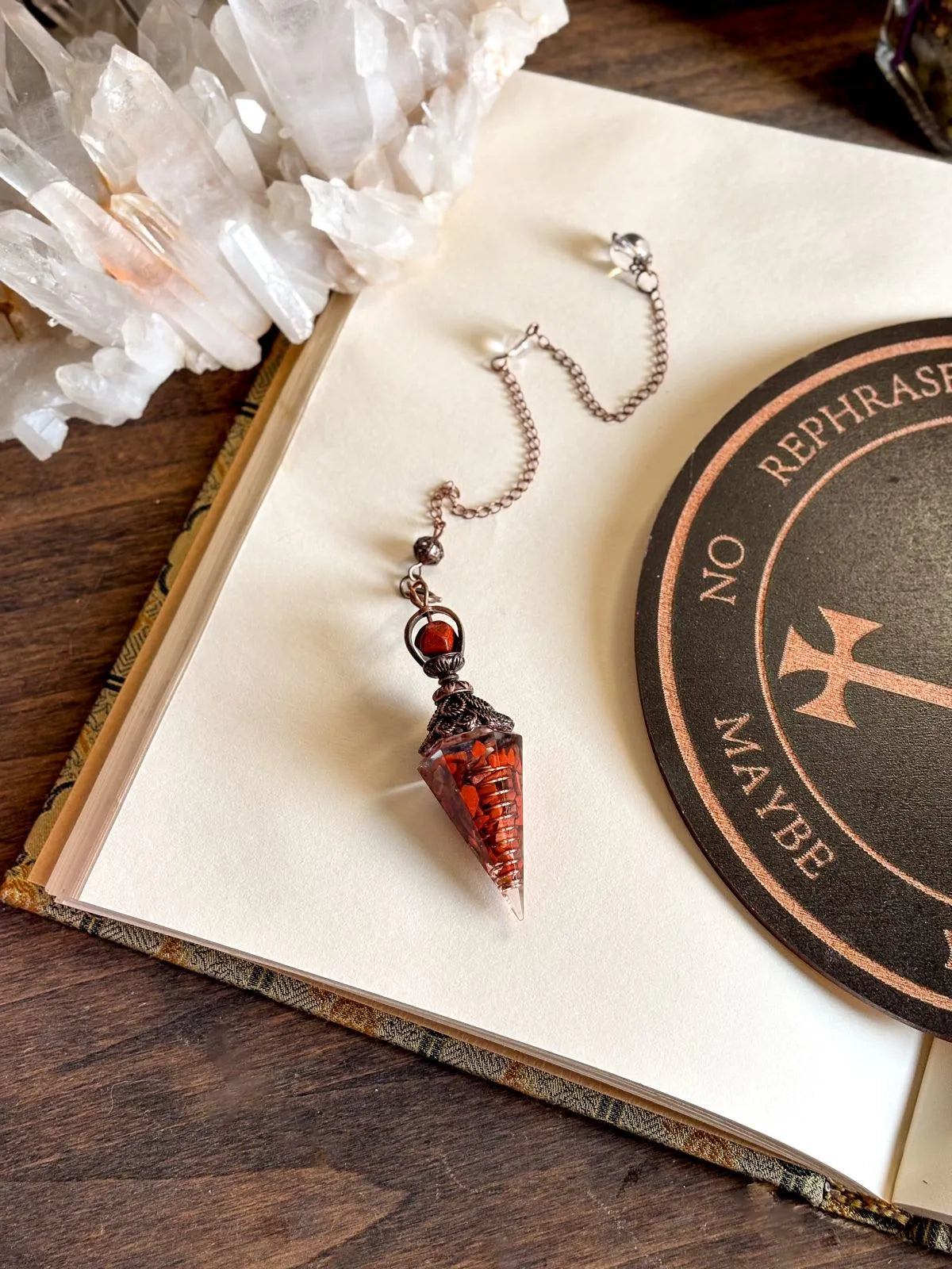 Handcrafted red jasper and copper pendulum for grounding and spiritual work.