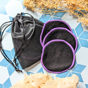 Elevate your makeup routine with this set of 3 machine washable black makeup rounds, elegantly finished with a purple edge. Available at Goddess Provisions