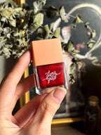 Deep scarlet nail polish symbolizing passion, energy, and empowerment.