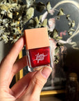 Deep scarlet nail polish symbolizing passion, energy, and empowerment.
