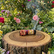 lavender smudge wand with rose petals and strawflowers for energy cleansing rituals