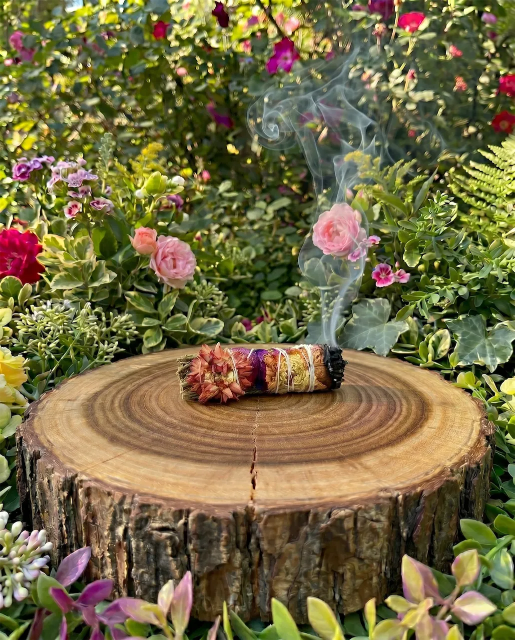 lavender smudge wand with rose petals and strawflowers for energy cleansing rituals