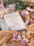 Starlight Frequencies Oracle Deck with Crystals and pink flowers in the background