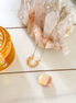 Gold-plated stainless steel sun pendant necklace with celestial design.