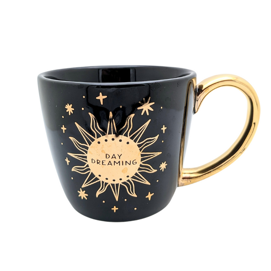 Black and celestial ceramic mug with moon and sun design available at Goddess Provisions