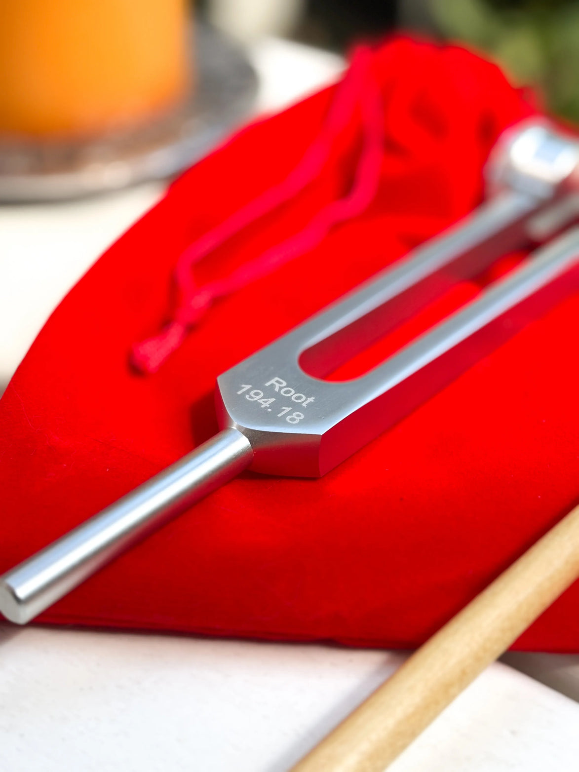 Root chakra tuning fork in silver for sound therapy, grounding, and energy alignment practices.