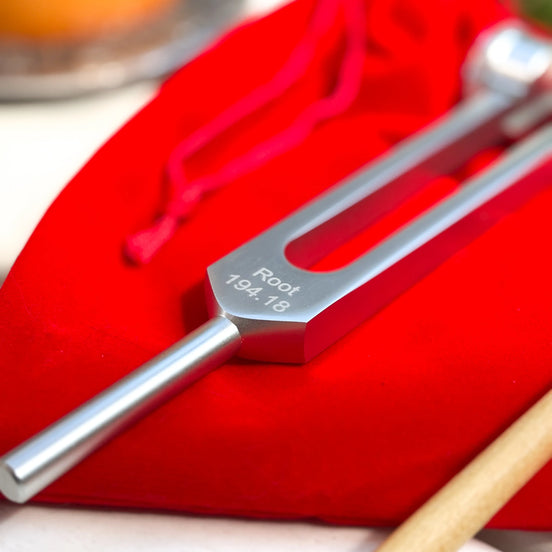 Root chakra tuning fork in silver for sound therapy, grounding, and energy alignment practices.