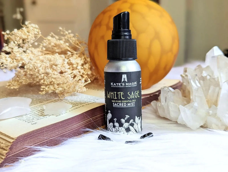 Reiki-charged white sage mist in an aluminum bottle surrounded by herbs and calming altar decor.