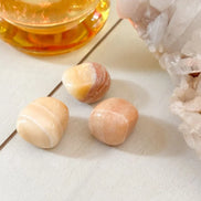 Yellow calcite tumbled stone used for positivity and inner light spiritual practice.
