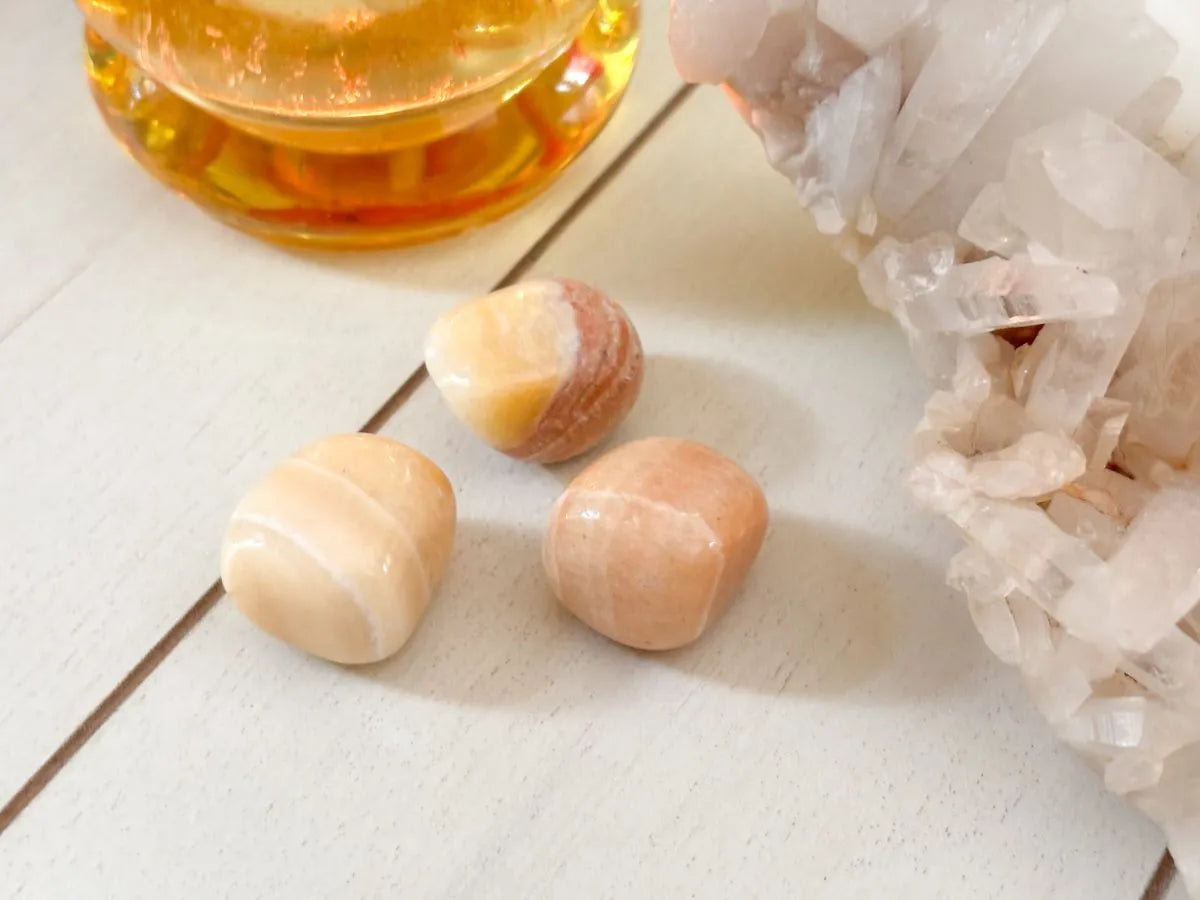 Yellow calcite tumbled stone used for positivity and inner light spiritual practice.