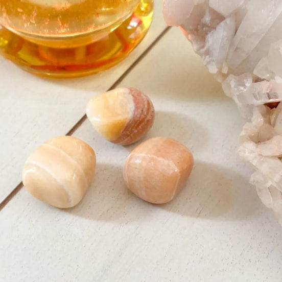 Yellow calcite tumbled stone used for positivity and inner light spiritual practice.
