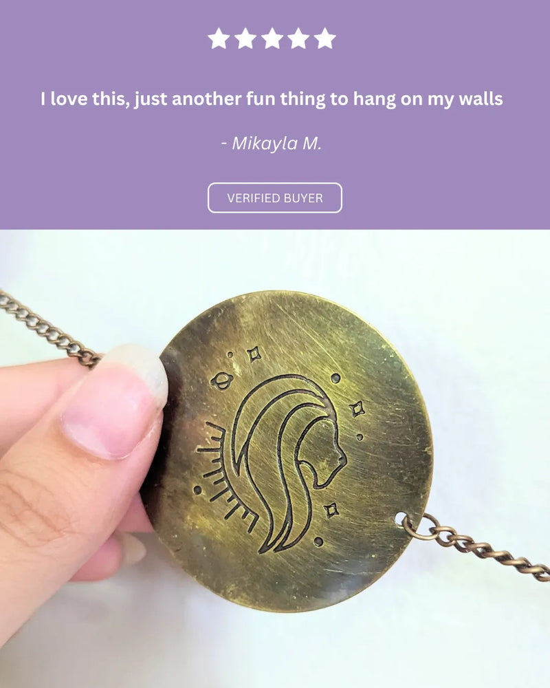 Positive review highlighting the size, antique finish, and beautiful astrological symbolism of the wall hanging.