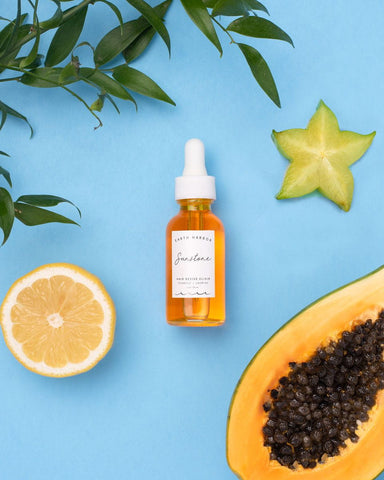 Amber glass dropper bottle of face serum for natural hair rejuvenation with Earth Harbor