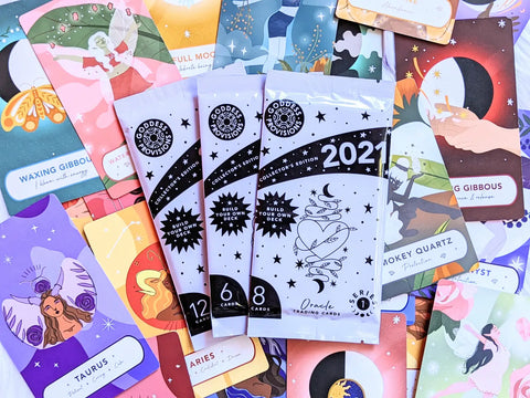 Assorted Oracle and Trading Card Packs displayed for A Magical Guide to Using the Oracle Trading Cards