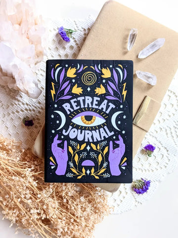 Black journal with colorful mystical design for self-love and retreat reflections