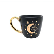 Black and celestial ceramic mug with moon and sun design available at Goddess Provisions