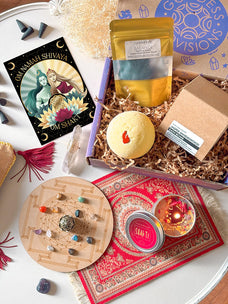 A past Goddess Box with oracle cards, a bath bomb, a crystal grid and ritual tools