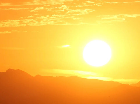 Bright intense orange-yellow Sun high in the sky for Lessons from The Sun article