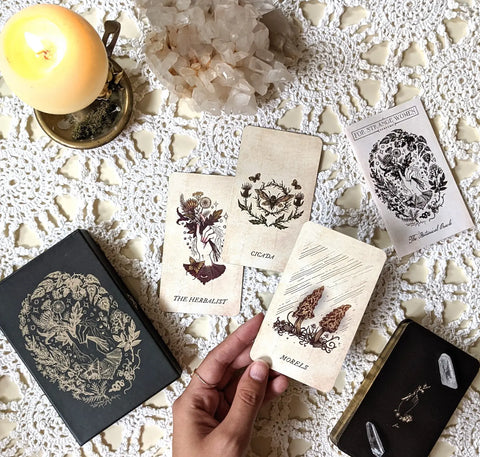 Botanical-themed oracle and tarot cards displayed for incorporating plants into your practice