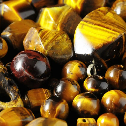 Polished Tiger’s Eye and Red Tiger’s Eye gemstones including tumbled stones and round beads