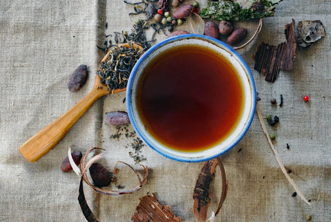 Cup of brewed black tea on a table for relaxing plant practice article