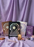 Set of tarot books and candles on a purple fabric background