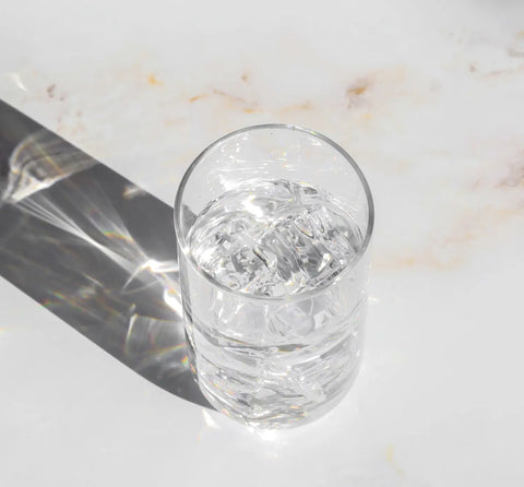 Glass of water with ice for a refreshing morning routine in a productive day article