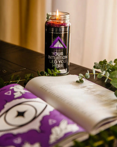 Lit purple candle in a glass jar for spiritual connection and intuition enhancement