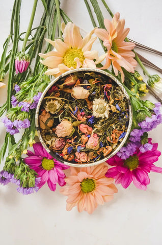 Loose leaf floral tea in a round metal tin for making flower essences
