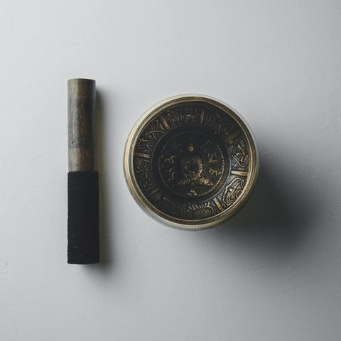Metal singing bowl with mallet for Throat Chakra activation in Aura purification article