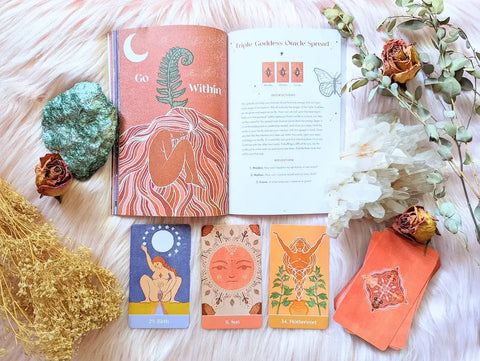 Mystical book and tarot card set for Sacred Cycles Journal cycle tracking