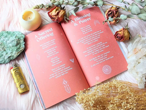Open Sacred Cycles Journal with coral-colored pages for cycle tracking and spiritual reflection
