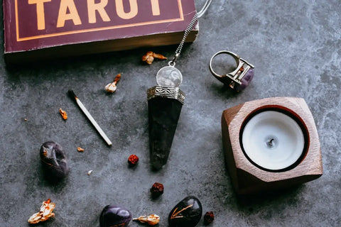 Pendulum with black crystal point and clear sphere hanging from a silver chain