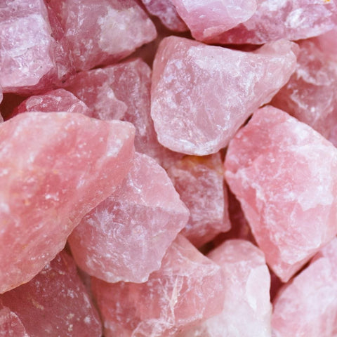 Pile of rough unpolished Rose Quartz stones for balance and healing