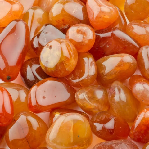 Pile of glossy Carnelian stones symbolizing energy and balance in crystals healing